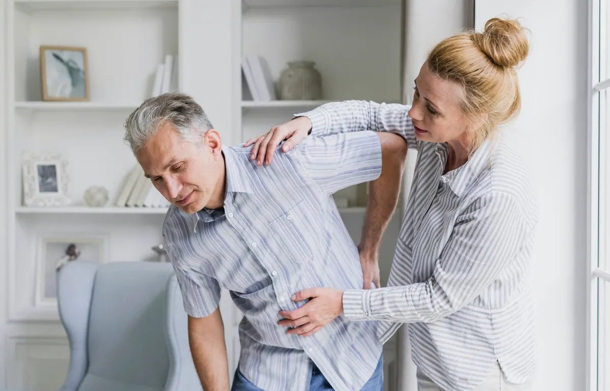 Female Chiropractor Adjusting Male Patient Spine