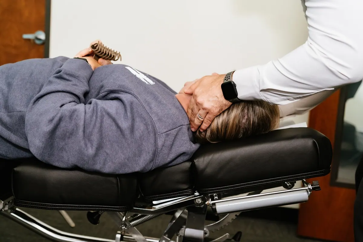 Chiropractor Performing Spinal Adjustment on Patient