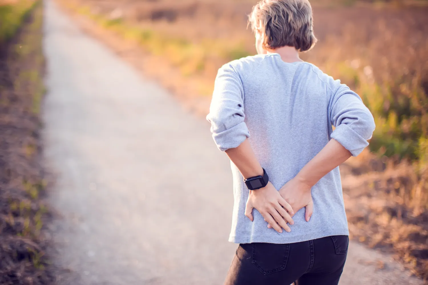 a old woman having a hip pain while walking