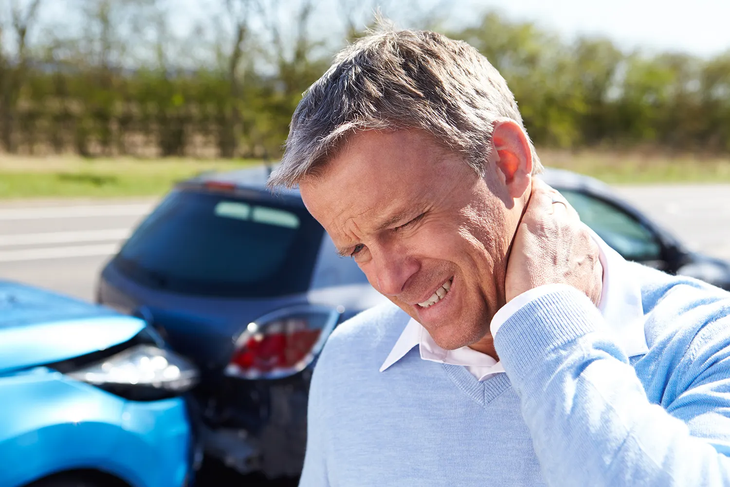 a old man having a whiplash after the car accident