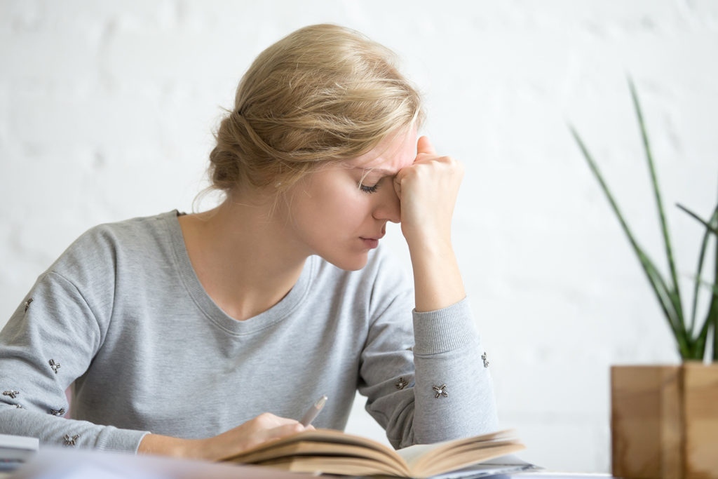 a woman suffering from vertigo after reading