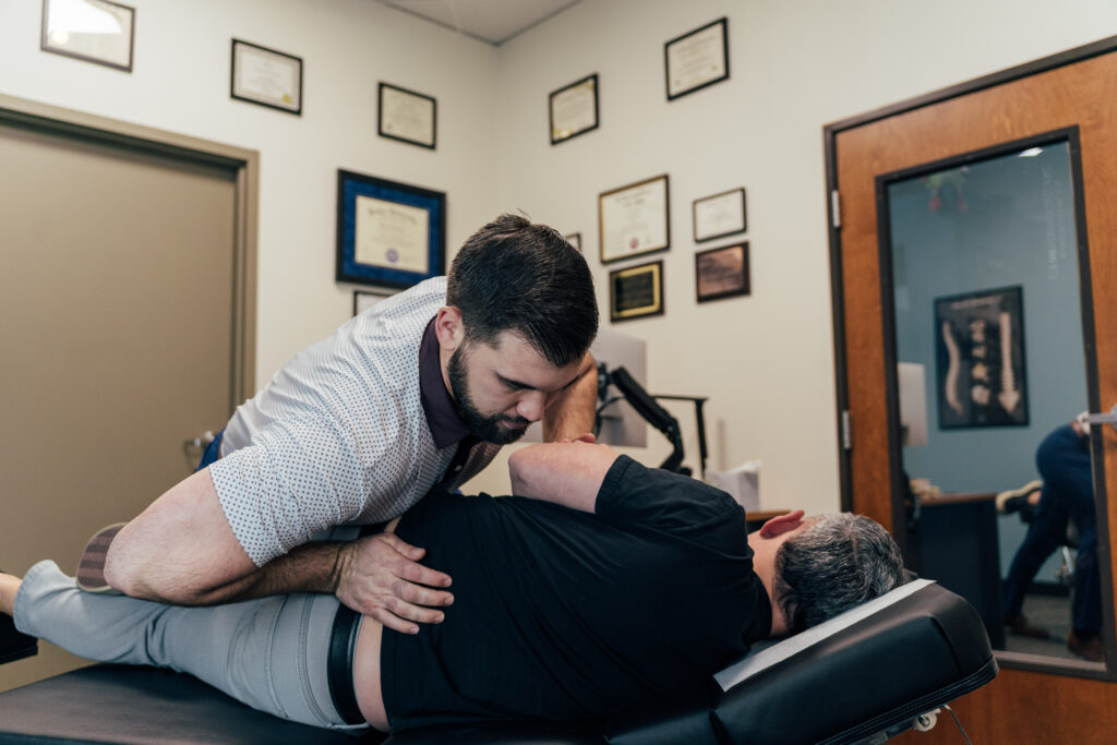 Dr Brent Johnson giving his patient a lower back chiropractic treatment